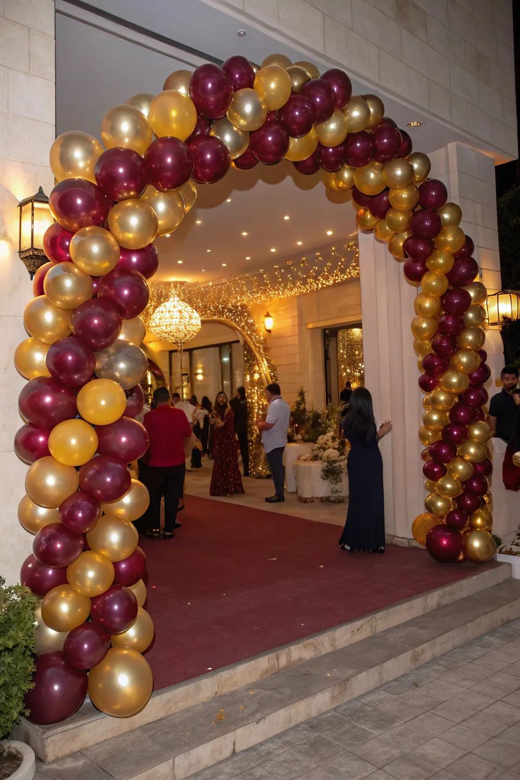 An eye-catching balloon creation in burgundy and gold graciously greets guests, extending grace and charm.