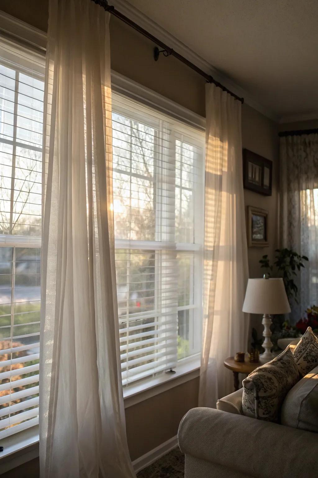 Lightweight drapes layered over sturdy blinds result in a sophisticated and gentle atmosphere.