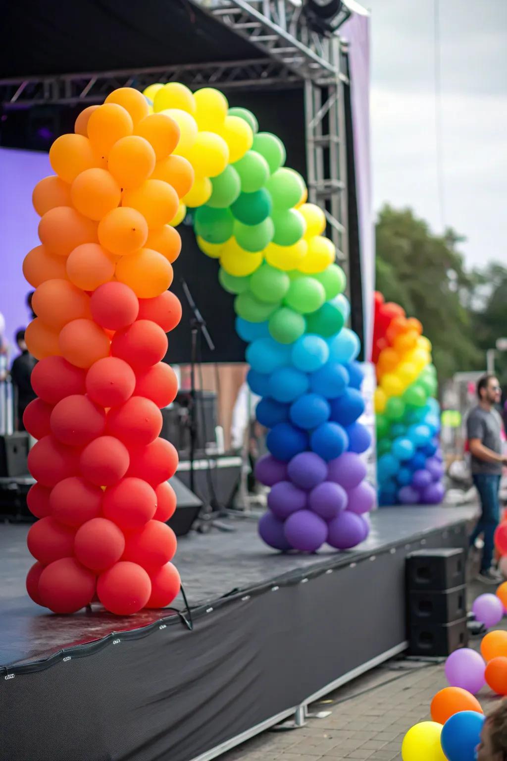 A stage showcasing a balloon decoration arrangement with a rainbow theme.