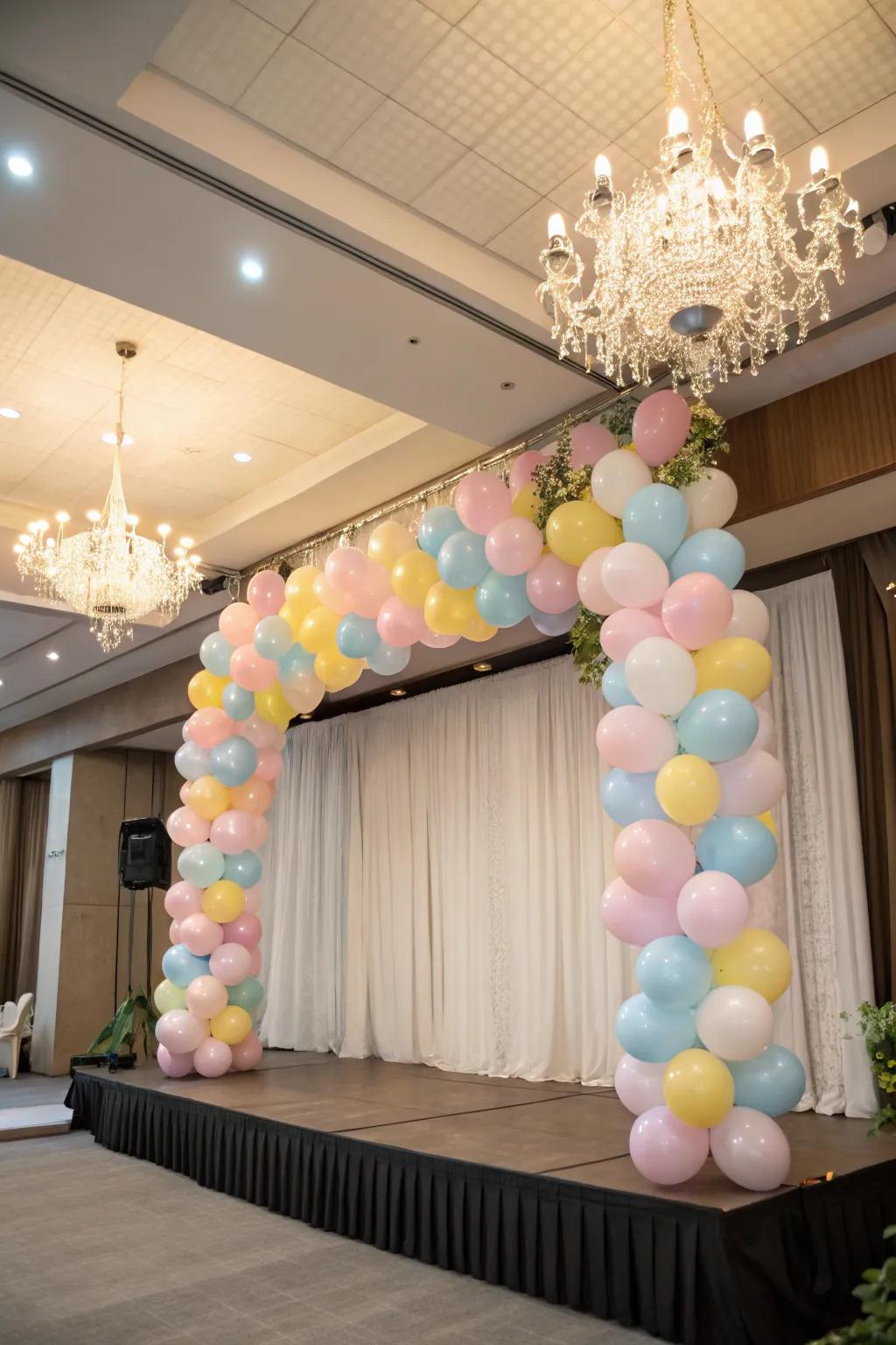 A whimsical balloon chandelier suspended above the stage.