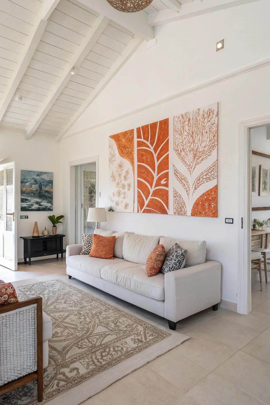 Orange and white artwork that brings cohesion and design to a living room.