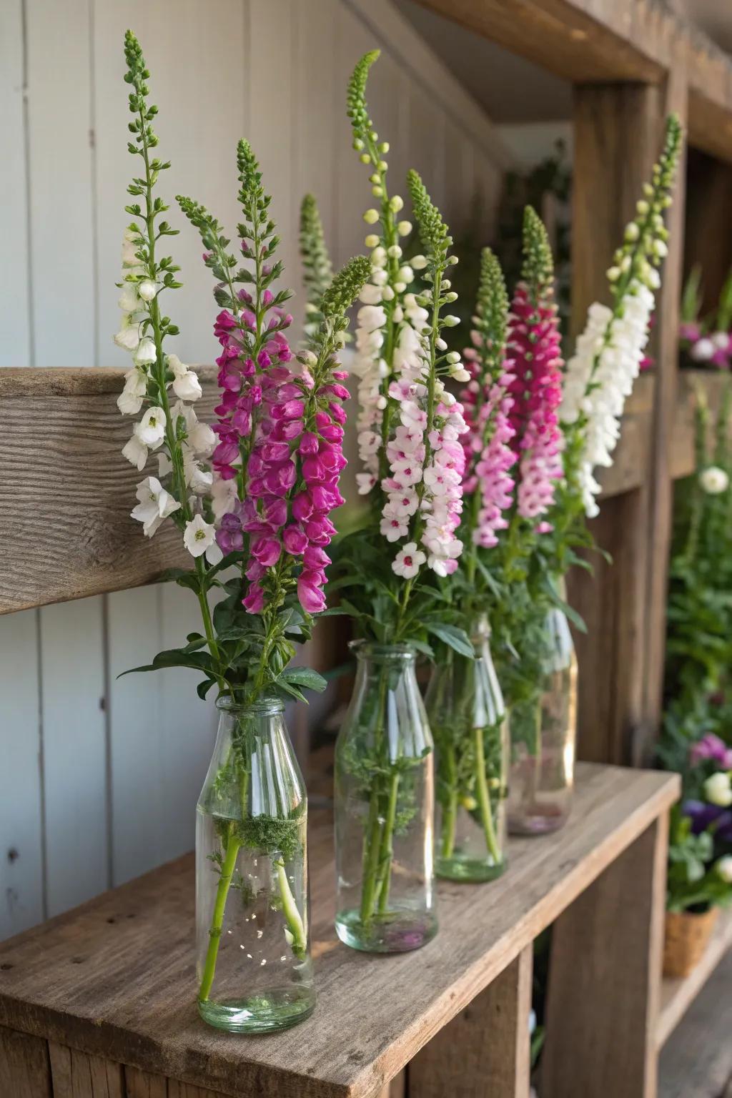 Glass bottles repurposed as vases create a sustainable arrangement.