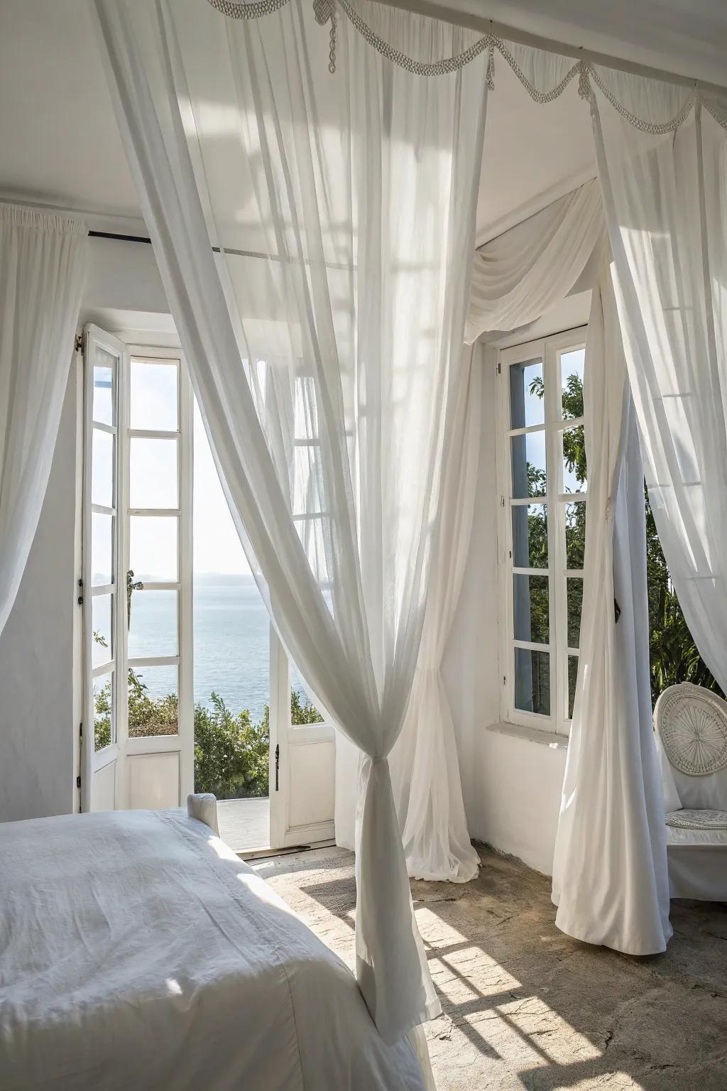 Elegant drapes enhance the airy feel of a white bedroom.