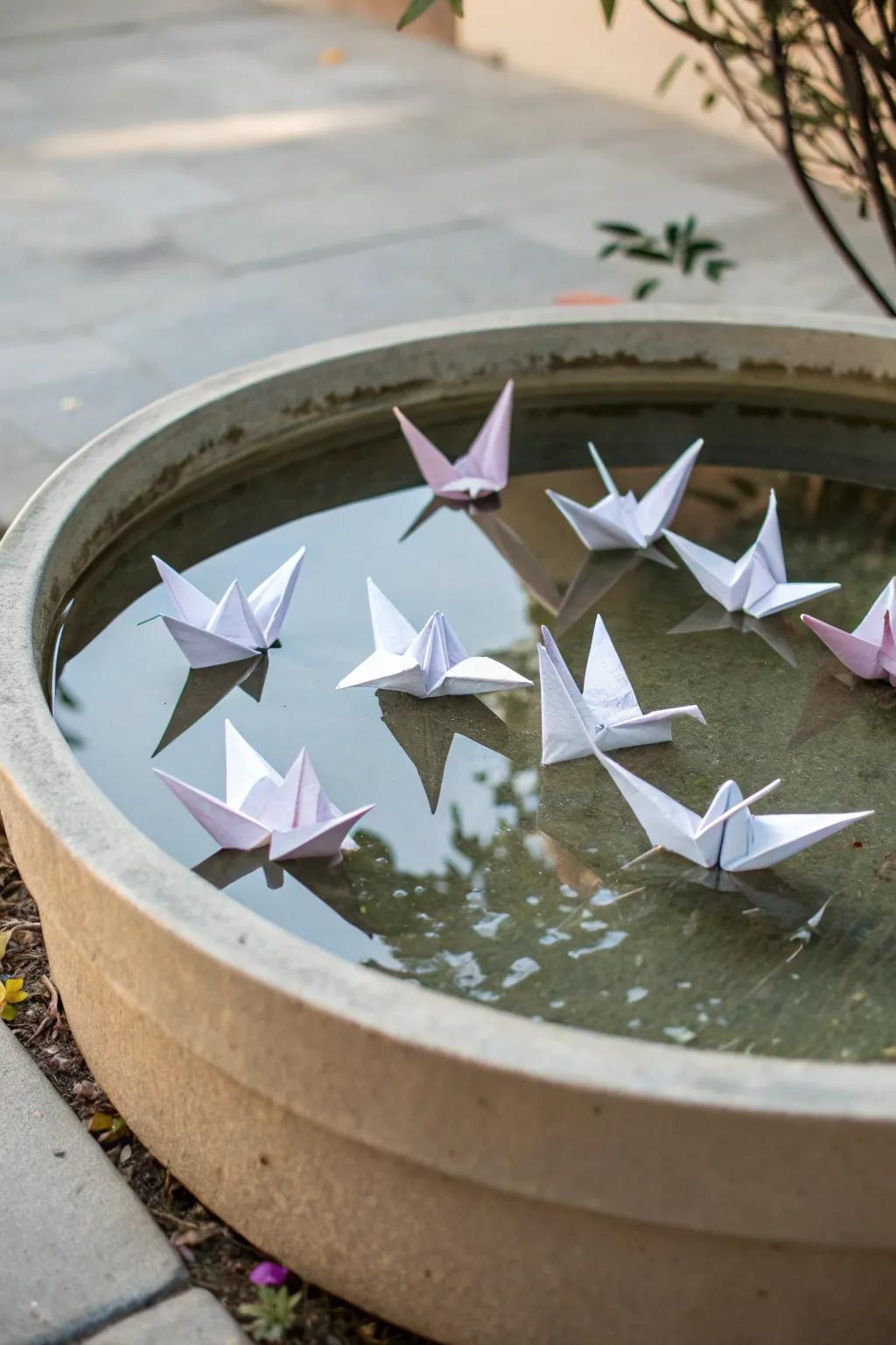 A serene reflection pond with floating cranes.