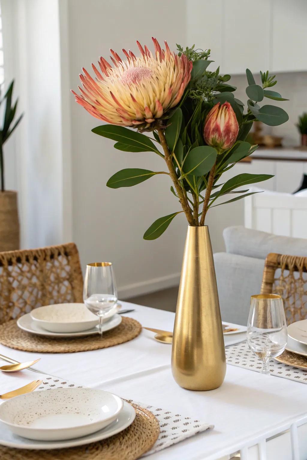 Minimalist sophistication with a single gold vase and bloom.