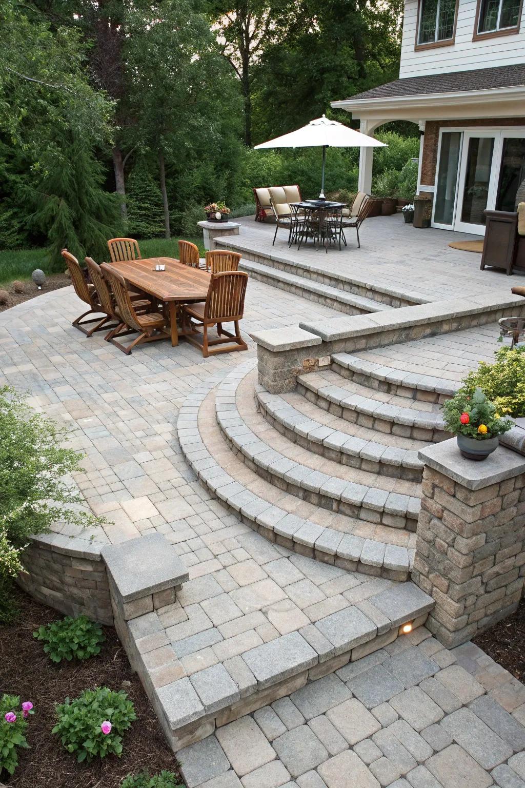 A multi-level paver patio with distinct zones for dining and relaxation.