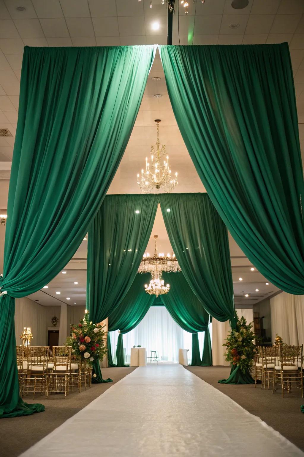 A venue transformed by elegant emerald green drapery.