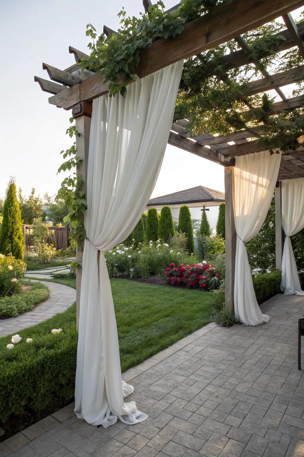 A pergola with drapes creating an intimate outdoor retreat.