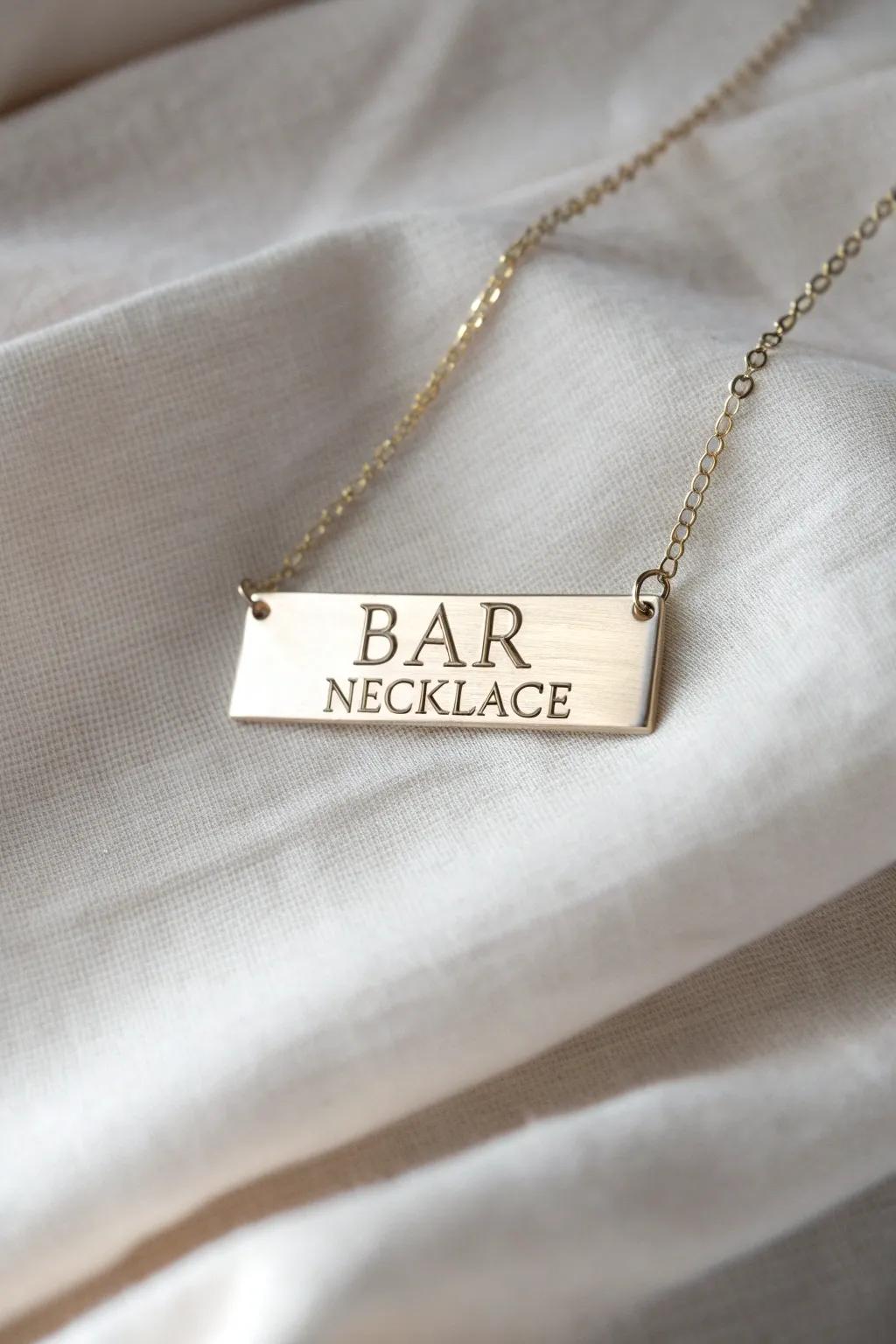 A modern bar necklace with personalized engravings.