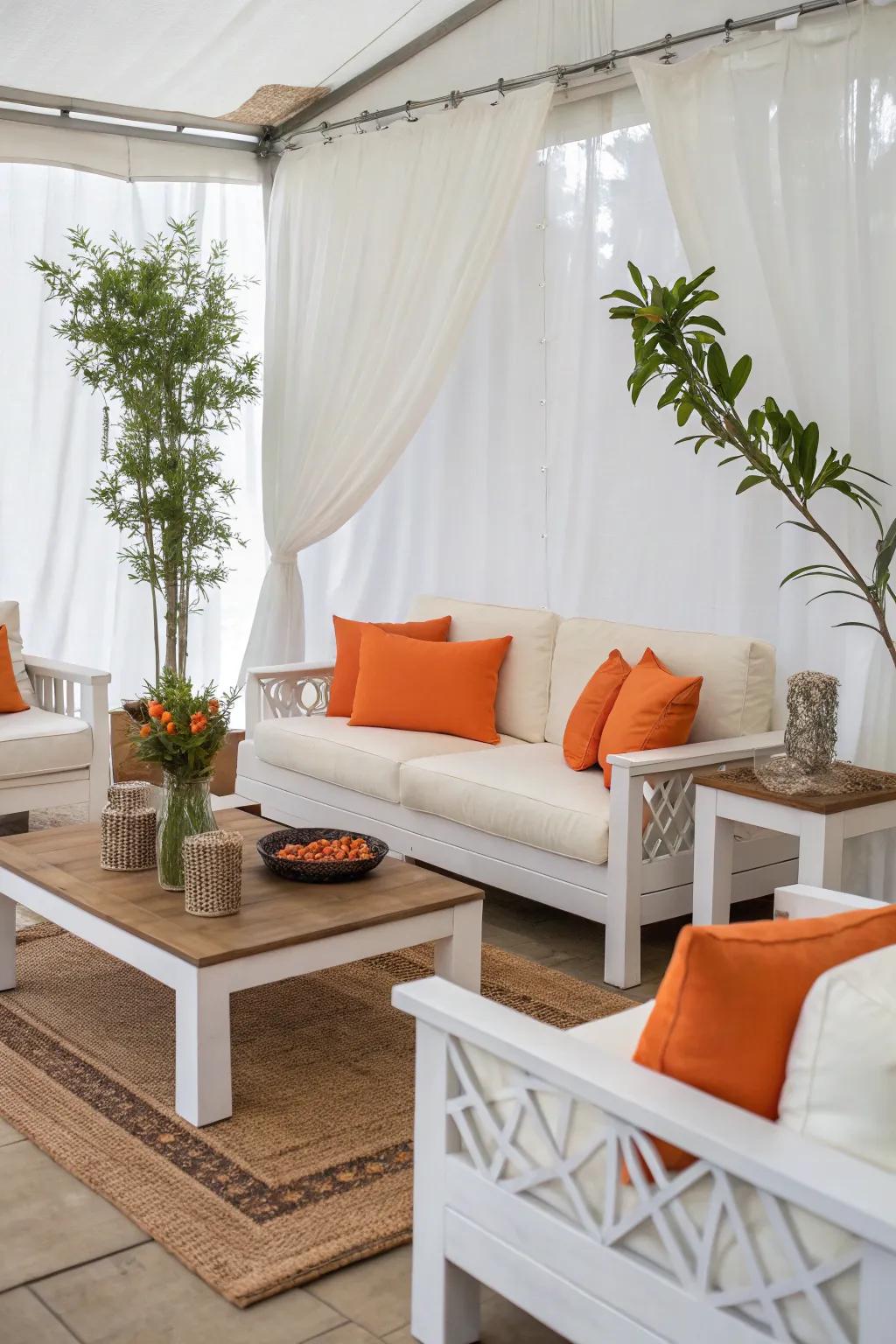 White furniture combined with orange cushions for a chic and classic design.