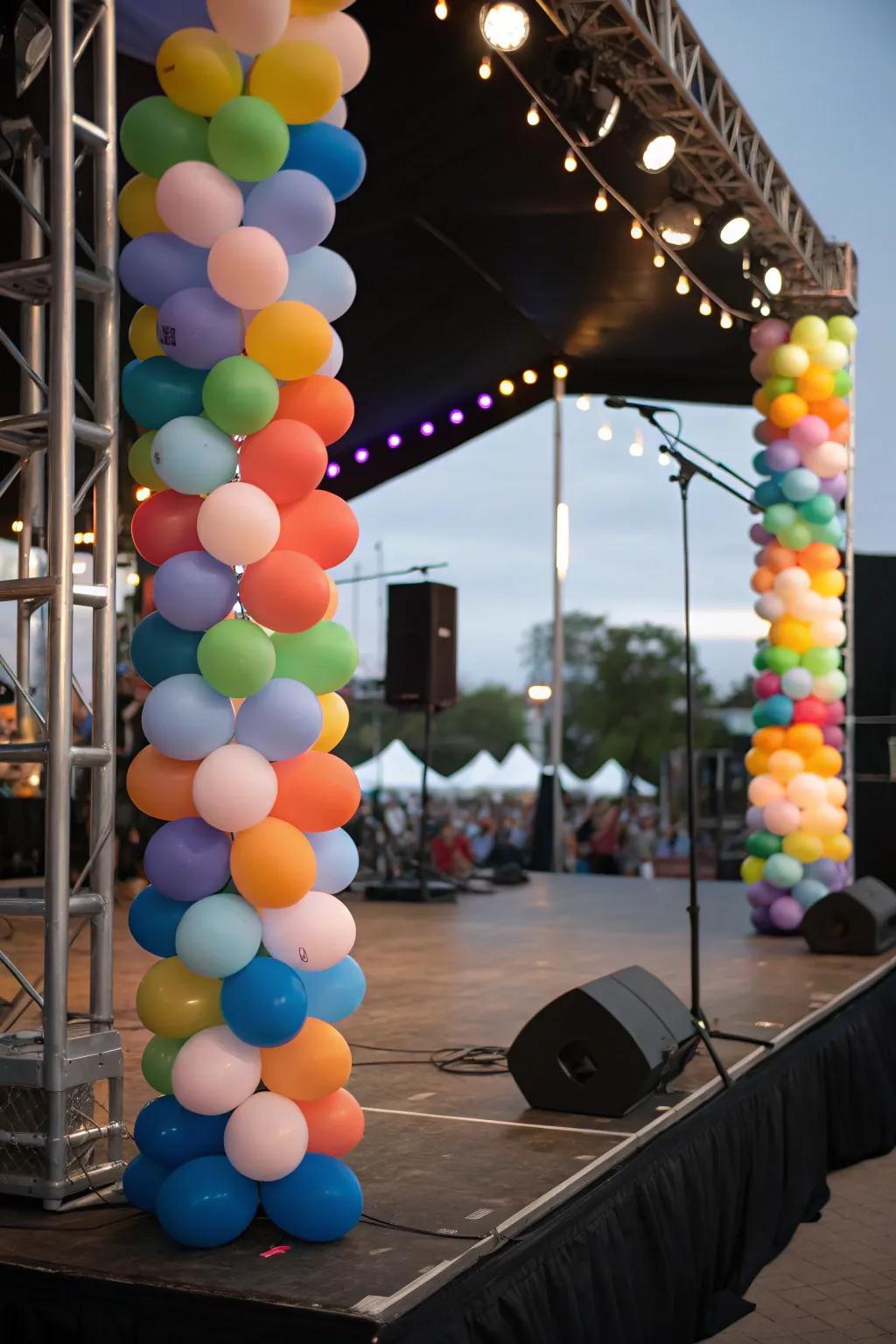 Balloon towers framing the performance area on the stage.